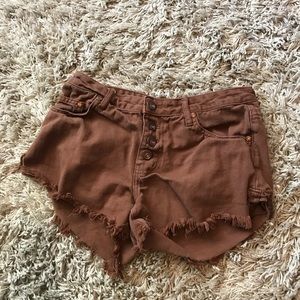 Frayed brown denim shorts.